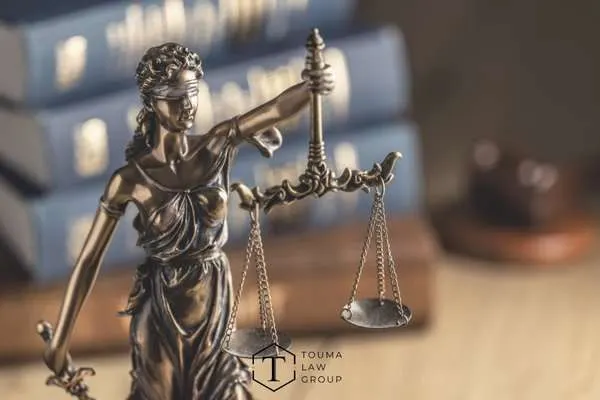 lady justice on a desk with books behind